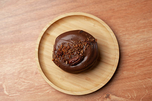 Delicious chocolate dessert with crunchy topping served on a wooden plate