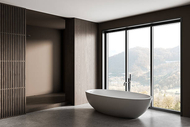 istock Modern bathroom interior with freestanding bathtub and panoramic mountain view through large window in minimalist design style. 3D Rendering 2227342633