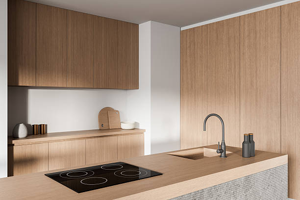 istock Minimalist modern kitchen interior with wood panel cabinets and sleek built-in appliances in soft lighting and neutral tones. 3D Rendering 2227342843