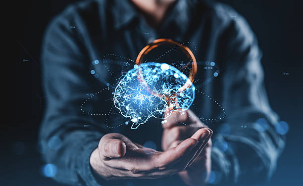 istock Futuristic concept of human intelligence and digital brain network held in hands with glowing neural connections and technology overlay on dark background. 2227342942