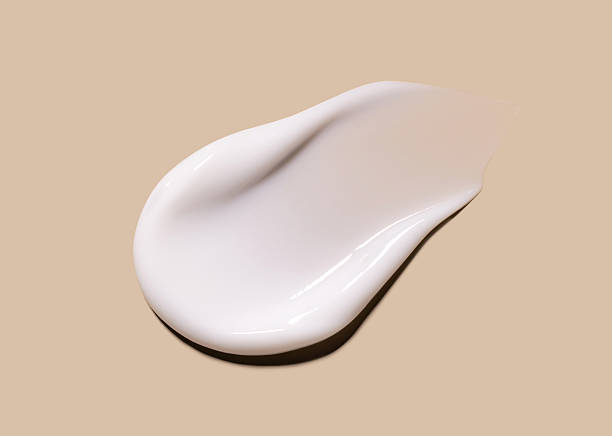 istock sample smear of creamy white texture on light beige background close up 2227344075