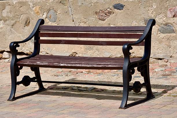 istock Old Wooden Bench Against Stone Wall. 2227345622