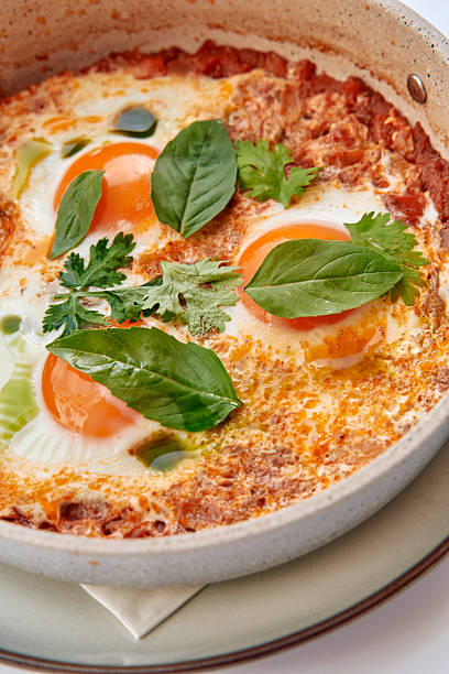 A Delicious Dish Featuring Eggs Poached in a Rich Tomato Sauce Garnished with Fresh Herbs for a Flavorful Culinary Experience