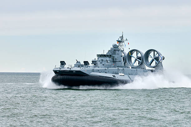 istock Hovercraft warship armed with armament sails into sea toward military target to attack and destroy 2227346265