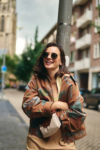 Stylish young woman smiling in urban setting