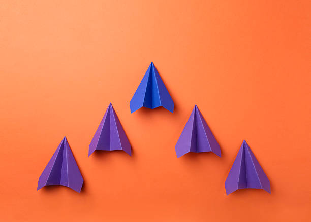 istock Handmade color paper planes on orange background, flat lay 2227347524