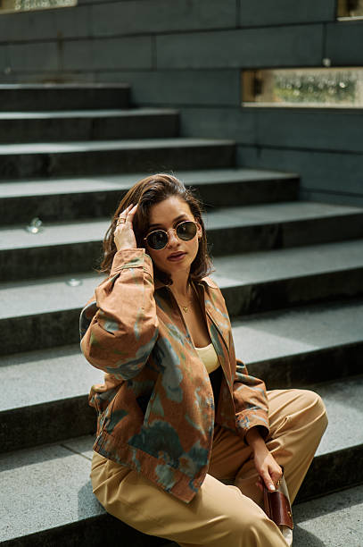 Stylish young woman posing on urban steps