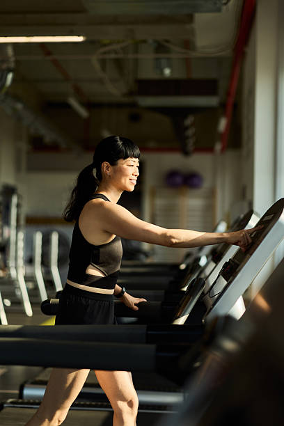 istock Woman Using Treadmill During Workout in a Modern Gym Environment 2227350001