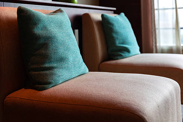 Comfortable corduroy armchair and sofa in a bright, minimalist living room
