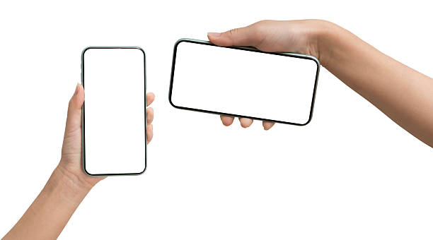 istock Two hands holding smartphones with blank white screen in vertical and horizontal positions isolated on white 2227350895