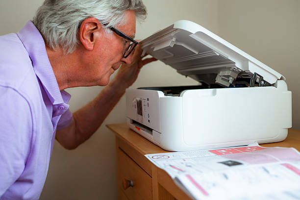 istock Senior man installing new printer in home office 2227351698