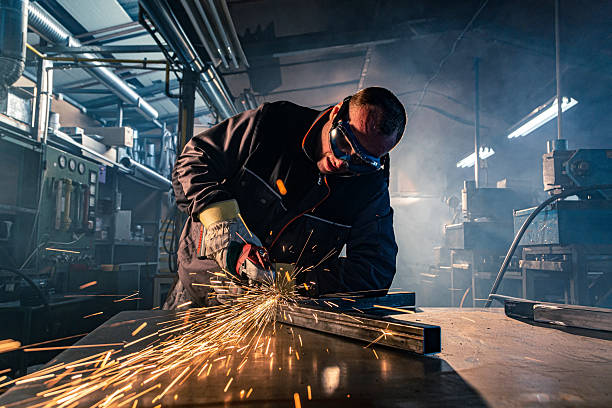 istock Metalworker grinding steel in workshop creating sparks 2227352861