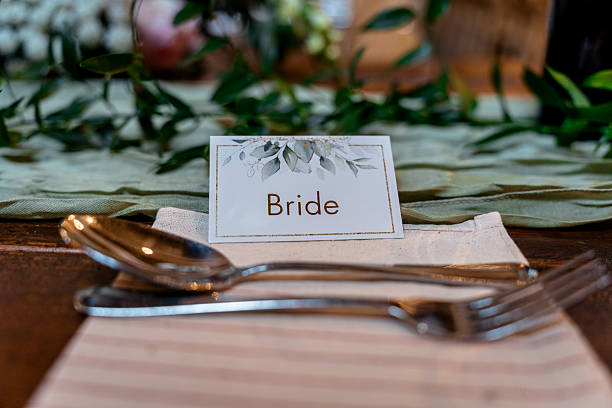 istock Bride place card at wedding reception breakfast in green 2227353104