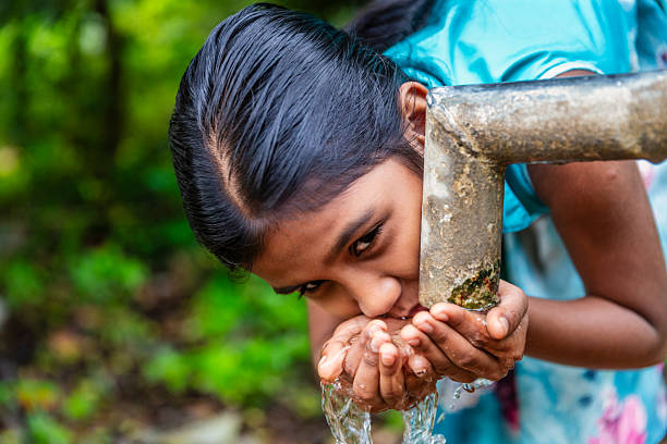 istock Sri Lankan young girl drinking a water, Ceylon 2227354162