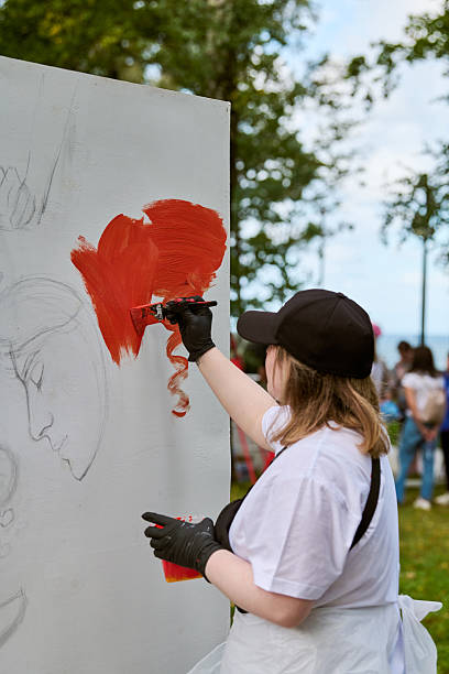 istock Female artist painting outdoors with energetic expression 2227354956