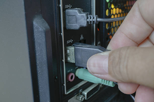 istock Person is connecting USB cable into computer port, showcasing technology and connectivity. image highlights importance of proper cable management and device setup 2227357398