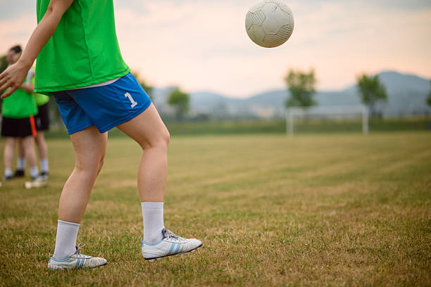 Beautiful blonde woman plays with soccer ball