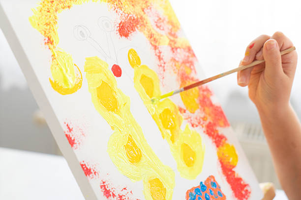 Young artist paints on canvas