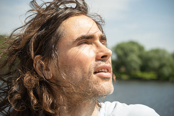 istock Thoughtful handsome brunette man with long hair 2227367352
