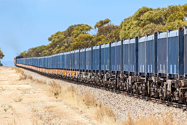 istock Freight Train loaded with Iron Ore in Blue Containers Heading to Port 2227370093