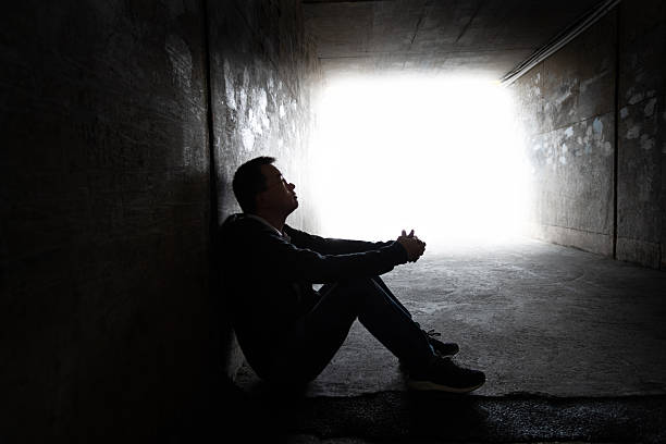 istock One man sitting in the dark tunnel 2227370406
