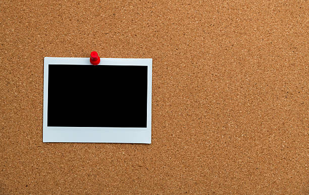 istock Single blank instant print pictures attached on cork board with copy space 2227371108
