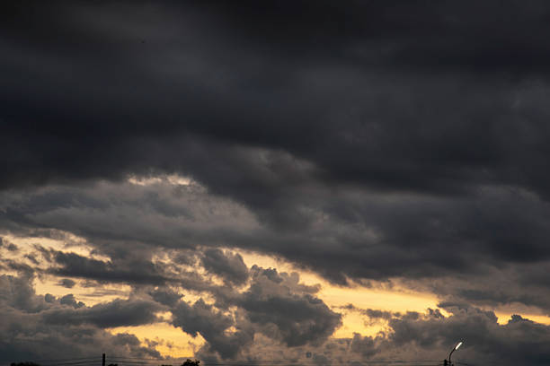 Dark rain cloud dramatic sky summer tropical thunder storm sky and fluffy black darkness cloud nearly raining cloudscape. Nimbus raincloud skyline climate background. Dark gray sky cloudy environment
