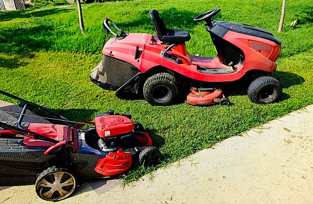 istock Lawn mower and cutted green fresh grass 2227376345
