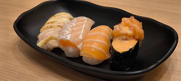 istock Sushi on a black plate on a wooden table 2227379707