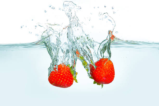 istock Fresh Strawberries Splashing Into Clear Water With Bright Bubbles 2227379767