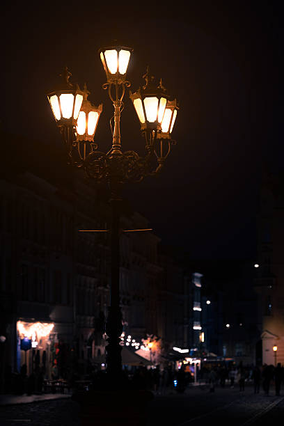 istock vertical long exposure lantern night city square light foreground and walking people's silhouettes background 2227380012