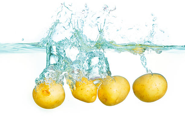 istock Fresh Potatoes Splashing Into Clear Water Creating Bubbles and Ripples 2227380930
