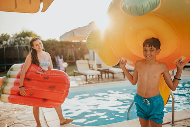 istock Boy enjoying summer fun with pool floaties during a sunny day at home 2227382247