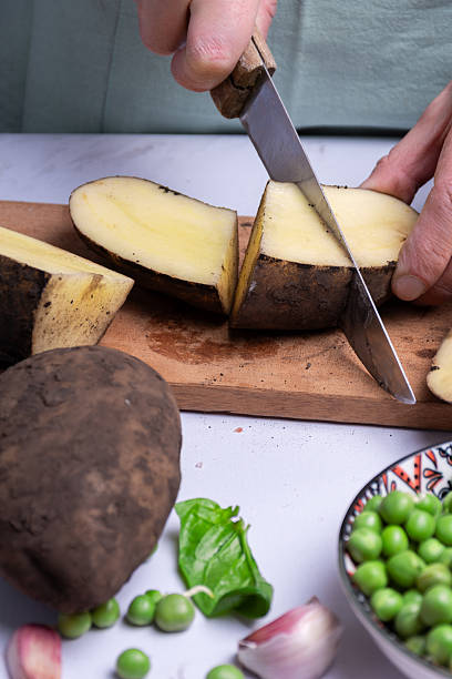 istock Cutting potatoes and other vegetables for cooking. 2227383524