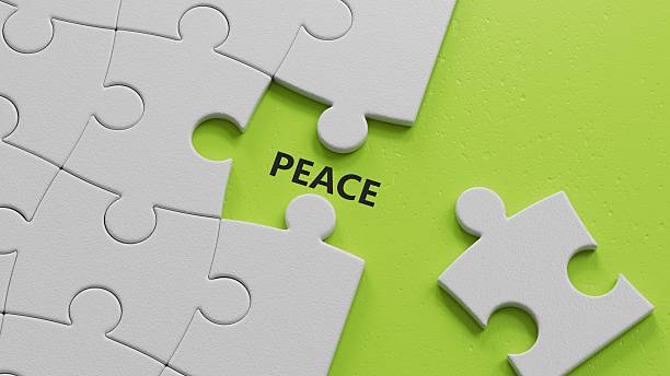 istock Peace. The white puzzle pieces with missing pieces form the word Peace. An extensive concept of the word Peace used in various areas of business and life.3D rendering on green background. 2227384421
