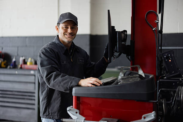 istock Car mechanic using computer for wheel alignment in auto repair shop 2227385875