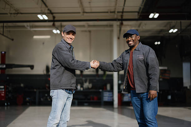 istock Two mechanics shaking hands in a garage 2227385993