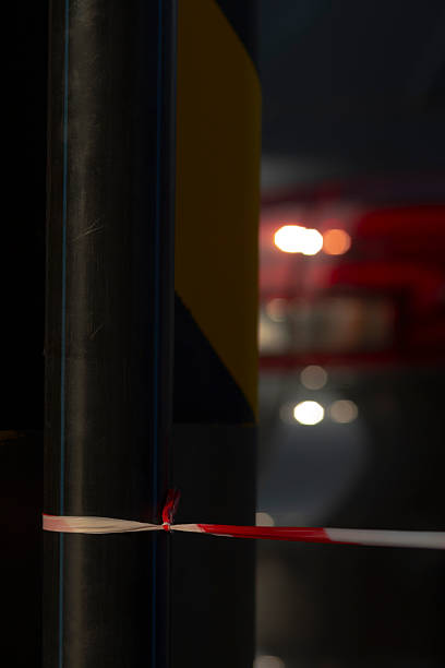 istock A red and white tape is suspended from a pole in a dimly lit room 2227387157