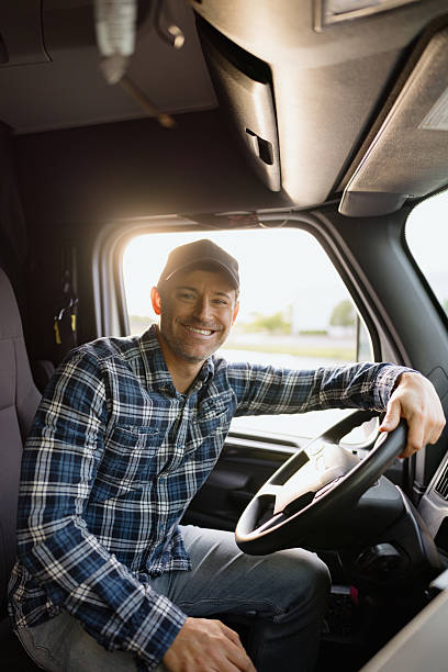 istock Trucker smiling and driving a truck 2227389364