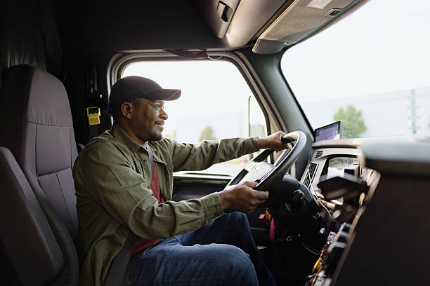 istock Truck driver smiling while driving his truck 2227389373