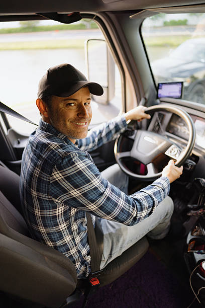 istock Trucker smiling and driving his truck 2227389402