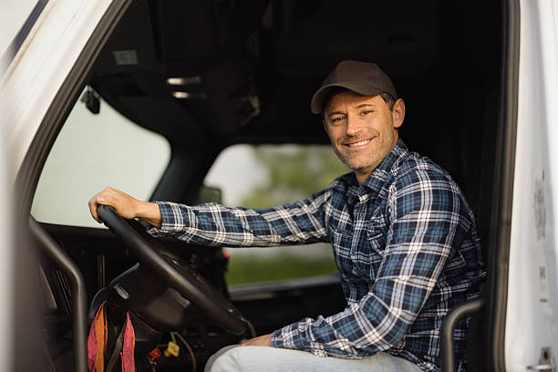 istock Trucker smiling and driving his truck 2227389427