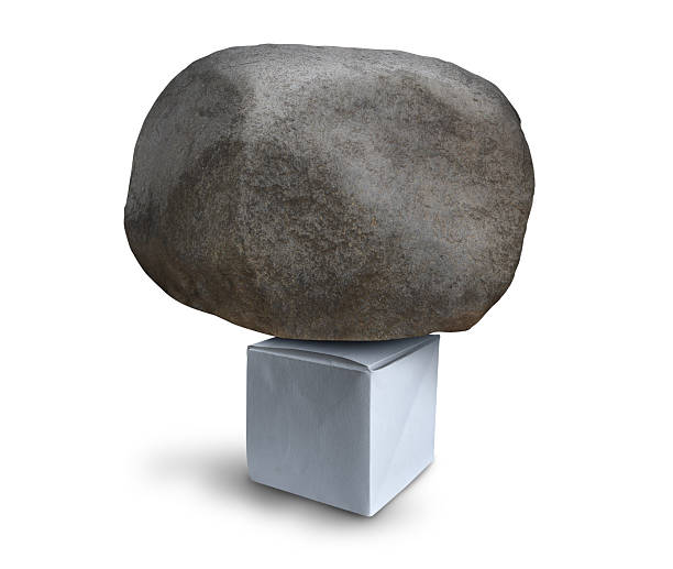 Power of Design and concept of strong engineering as a paper origami cube with a huge heavy rock as a metaphor for strength and designing as architecture and creative thinking as a clever idea for for achieving resilience.