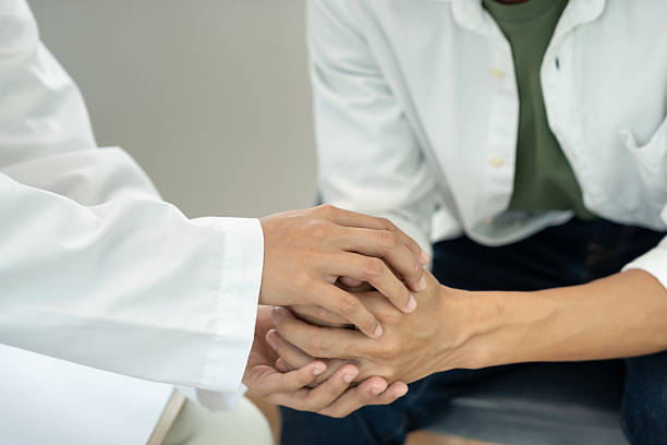 istock psychiatrist hold hand support each while discussing family issues. doctor encourages and empathy woman suffers depression. psychological, save divorce, Hand in hand together, trust, care 2227394411
