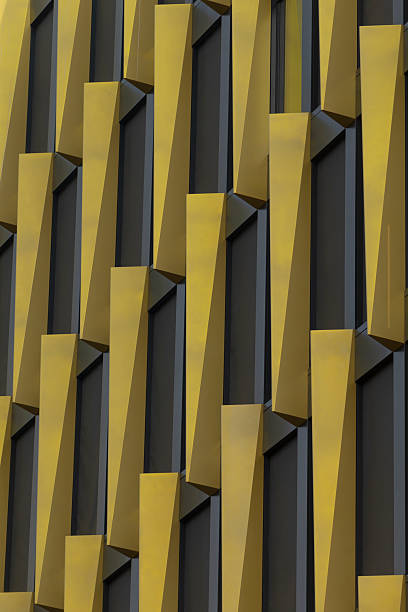 istock Closeup of a yellow and black building with a geometric pattern 2227395817