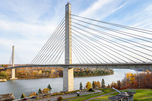 istock Modern concrete suspension bridge spanning a large river in autumn 2227396284