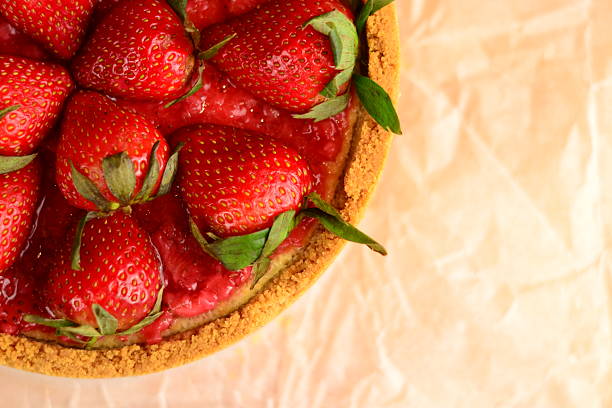 cheesecake with strawberry jam and fresh strawberries close up
