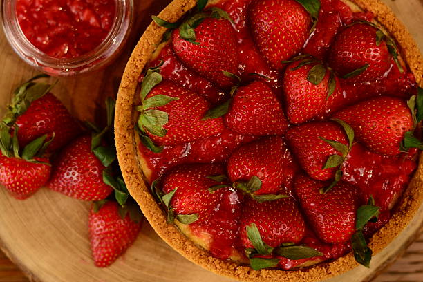 istock Full cheesecake with strawberry jam and fresh strawberries 2227398117
