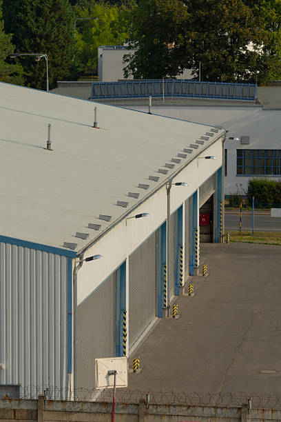istock A spacious warehouse featuring a white roof adorned with blue trim 2227398488