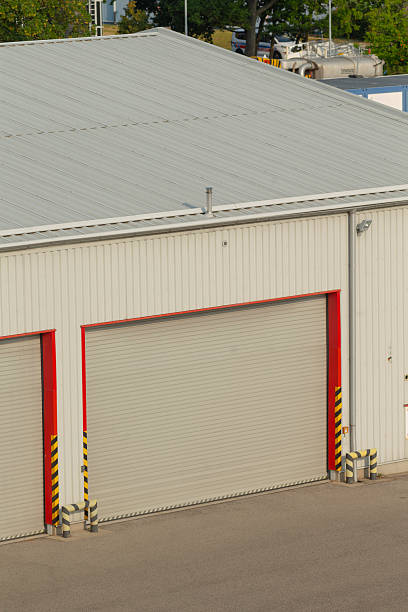 istock A white building featuring two spacious garage doors and a gray roof 2227400496